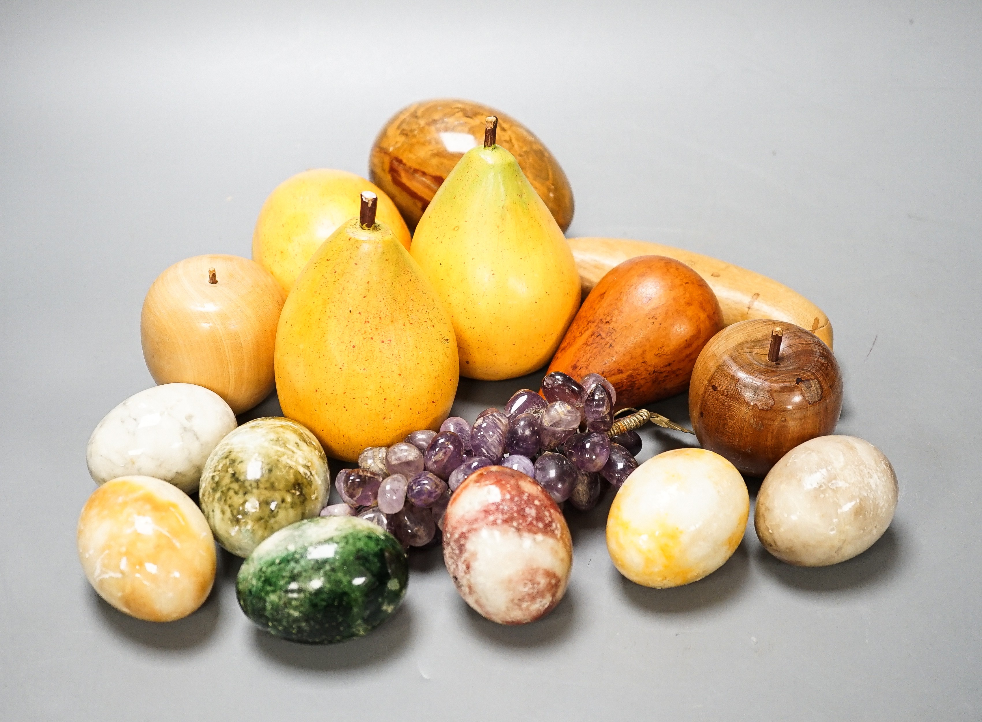 A group of polished stone and wood models of fruit, eggs, et.